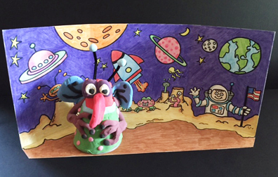 Clay alien in front of cartoon background