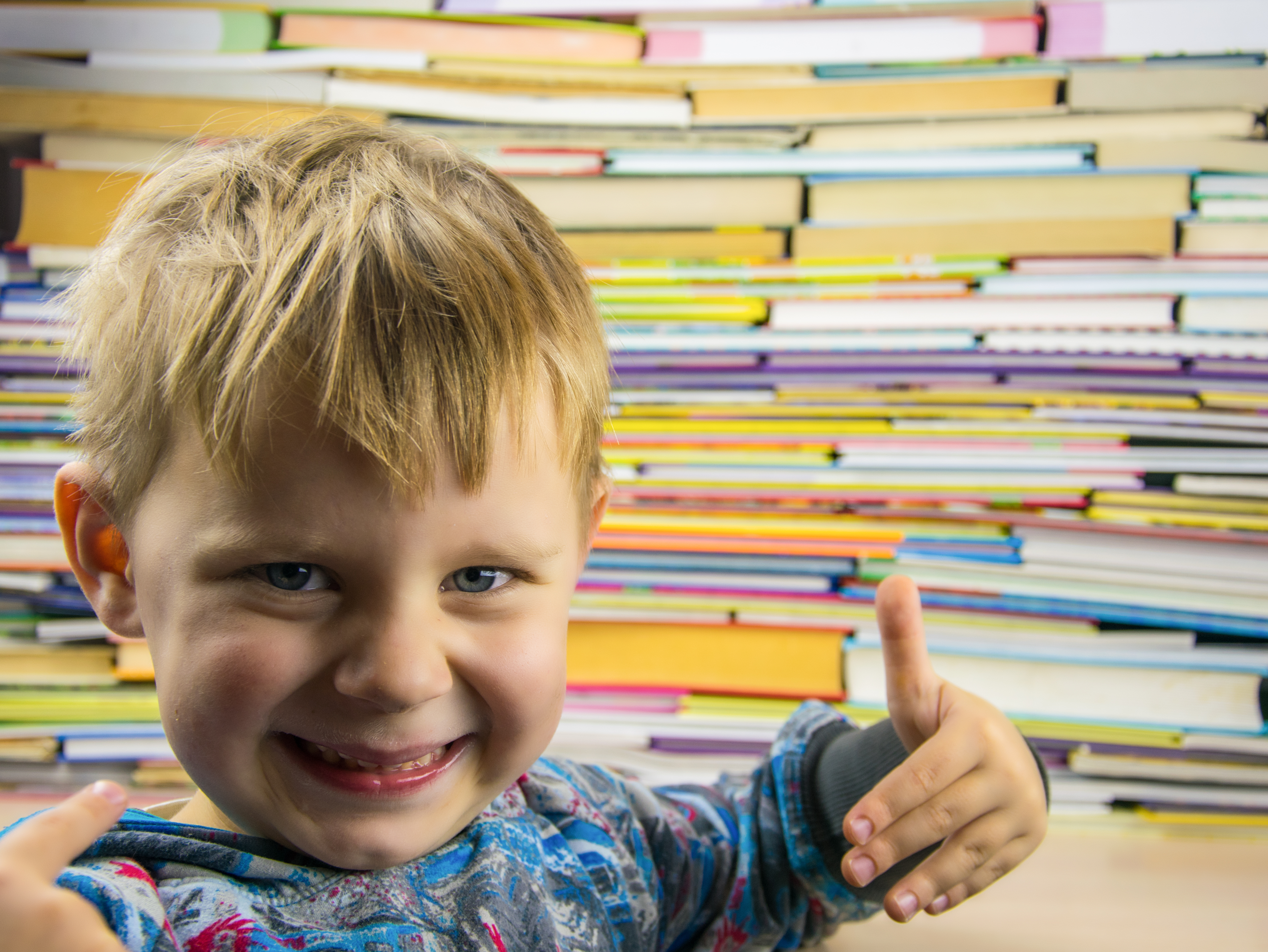 Little boy standing in front of books