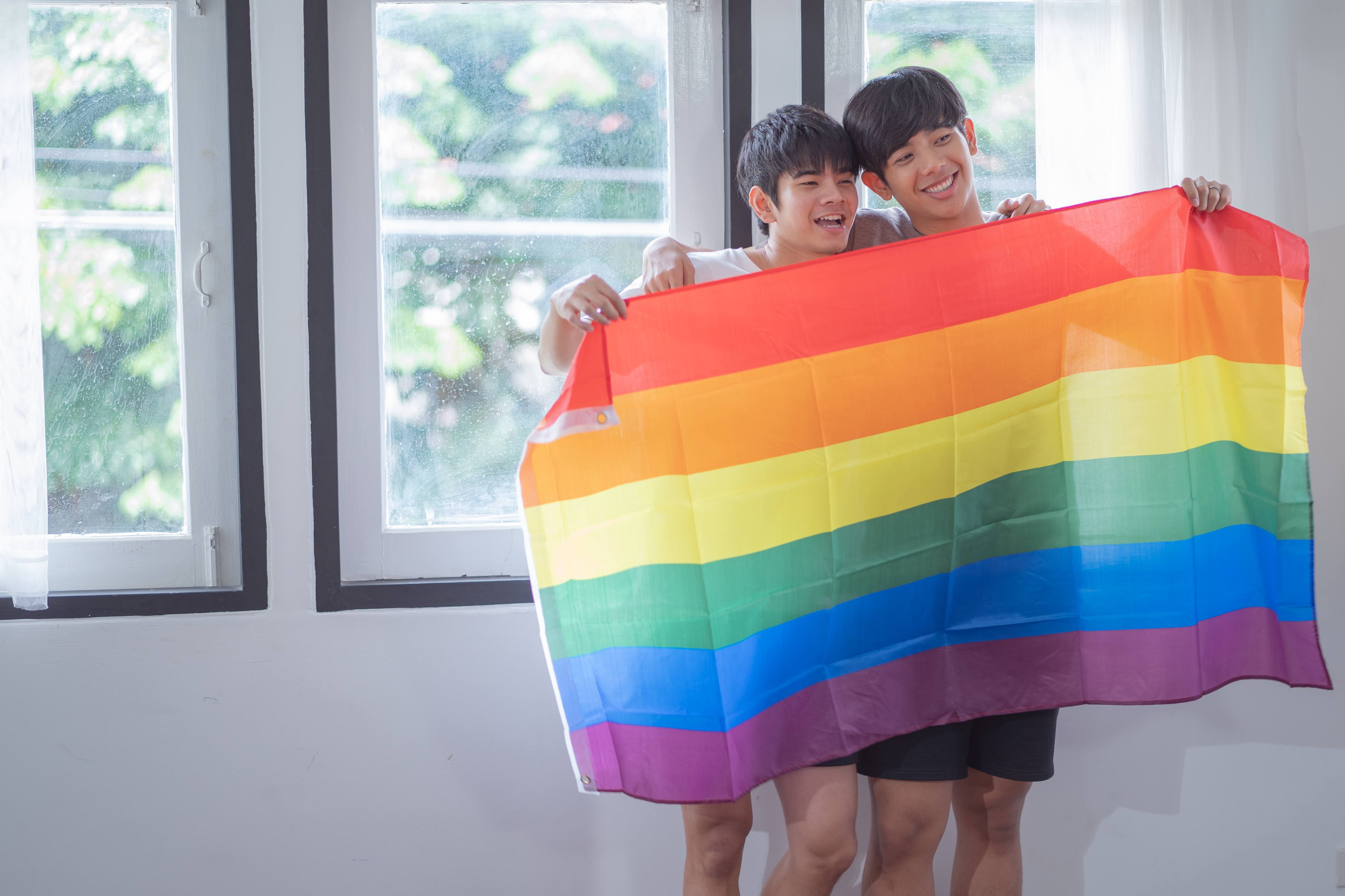 LGBTQ couple with flag