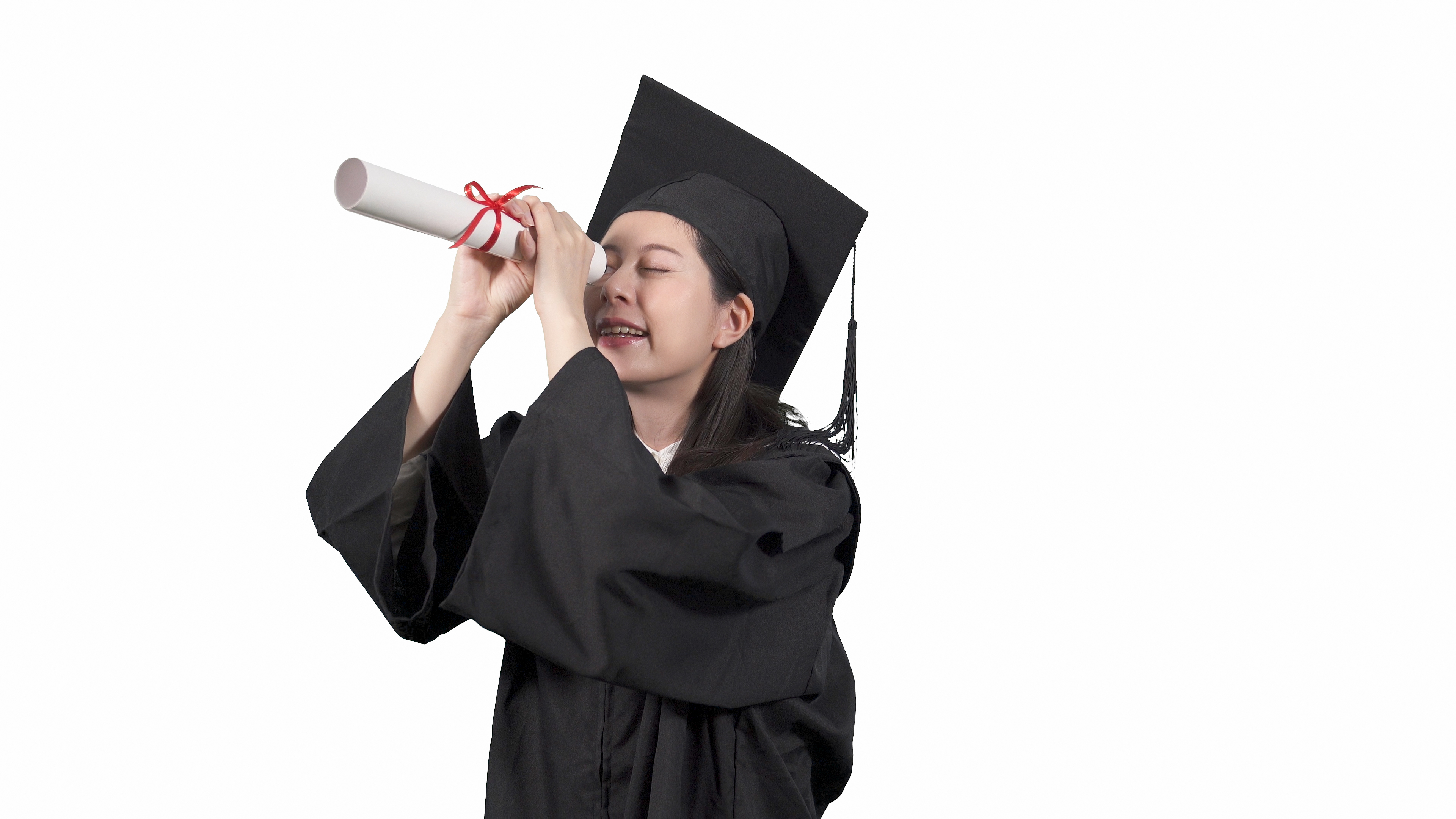 Graduate looking through rolled up paper