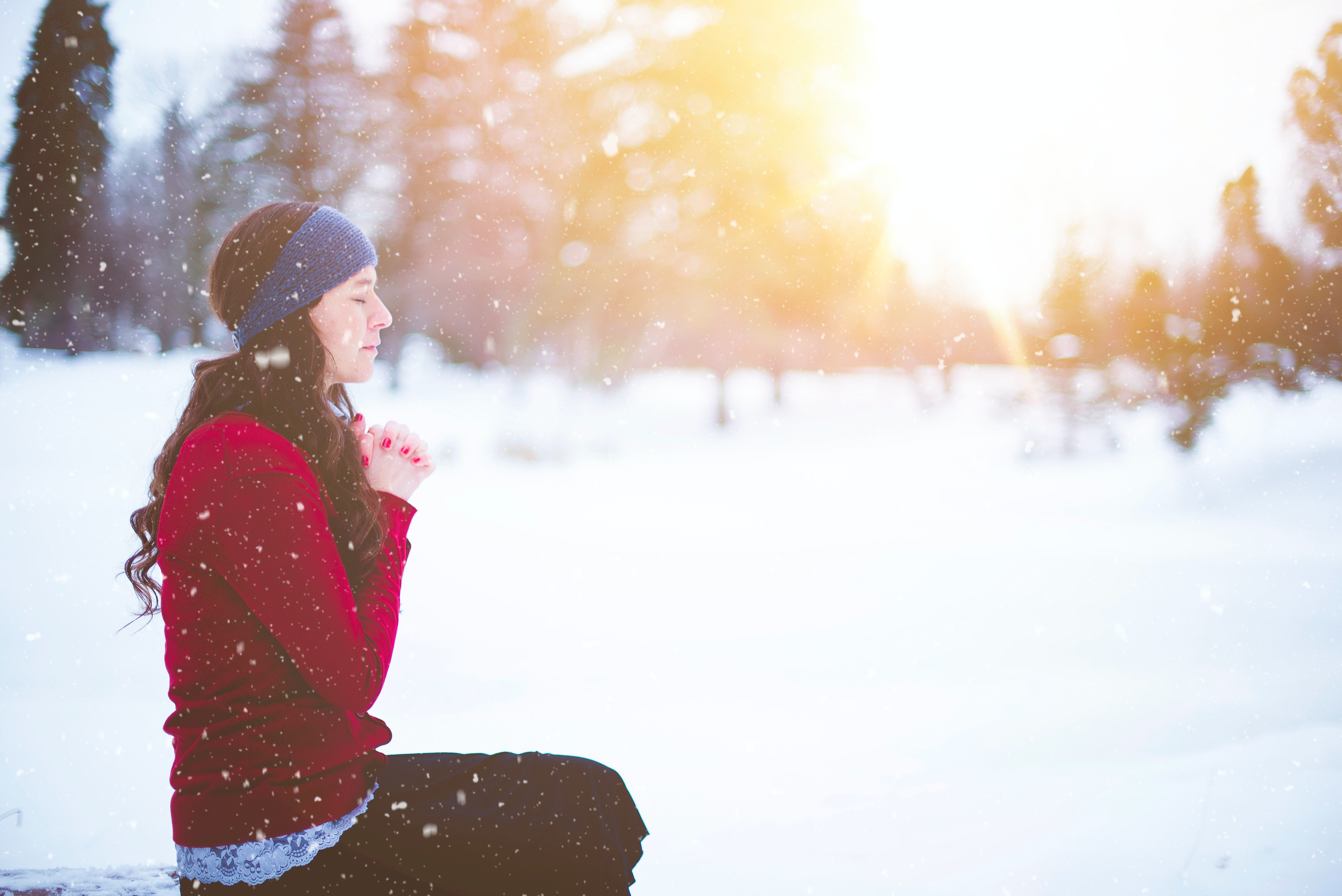 woman meditating in snow