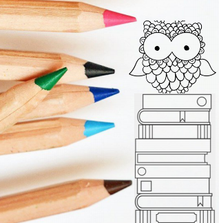 Colored pencils and drawing of owl on top of a stack of books