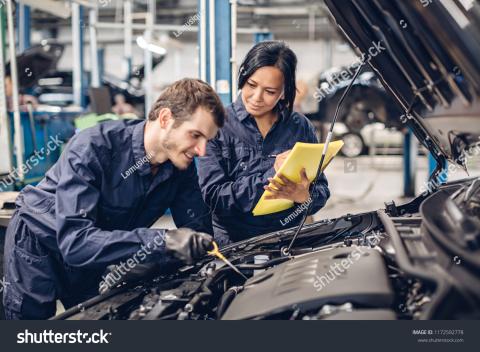 woman and man repairing car