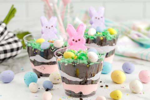 Pudding cups decorated with green coconut, candy eggs, and marshmallow bunnies.