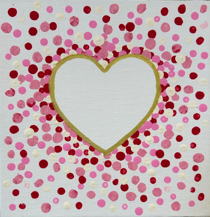Heart with red, pink, and white dots around it