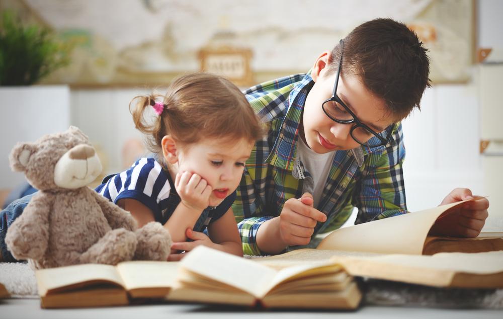 Teen and child reading together