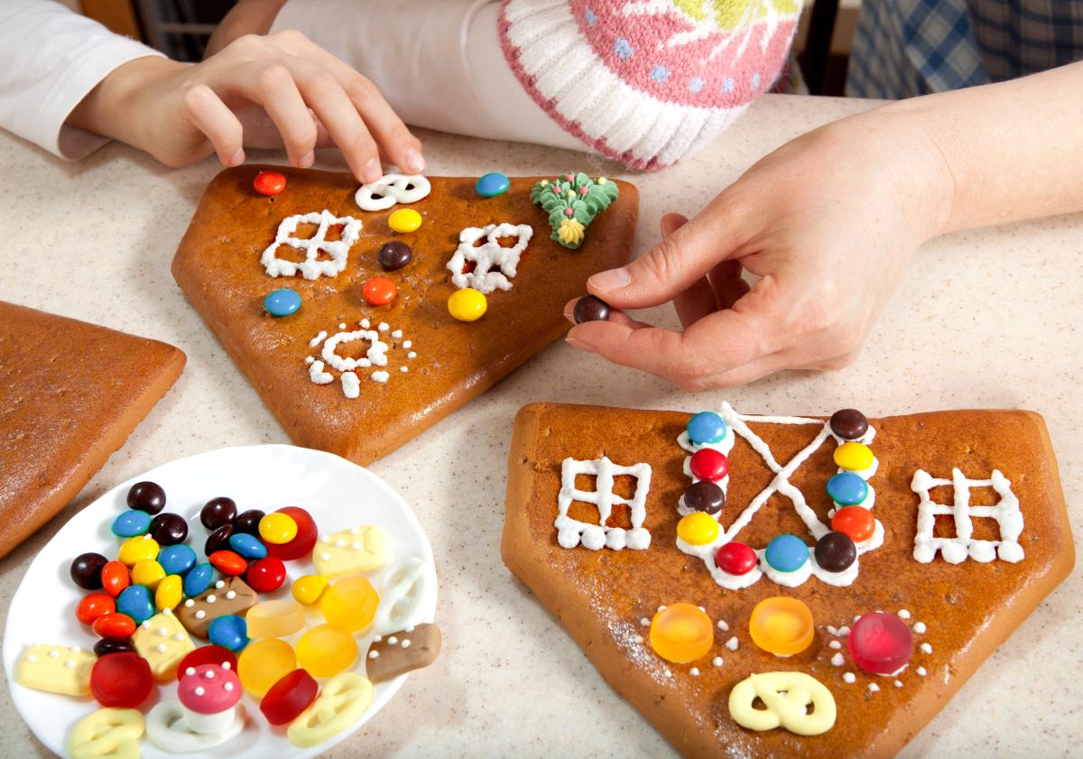 kid building a gingerbread house