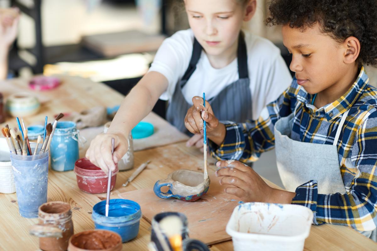 Kids painting clay molds