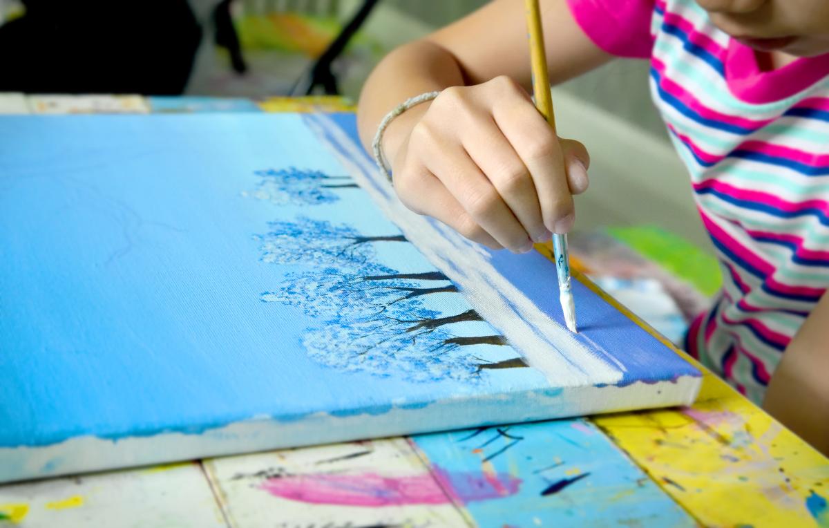 Kid painting a winter scene