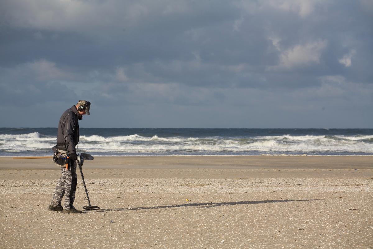 metal detecing on beach