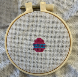 A pink egg with a blue stripe pattern