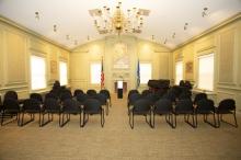 image showing memorial room with two sections of seating separated by a central aisle